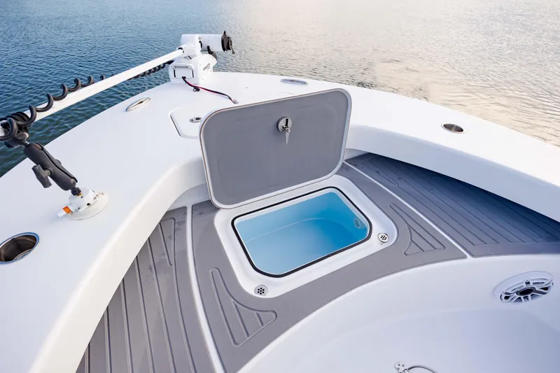 Slide: The Image of Open storage compartment on 2021 ZCB 26 Freemason boat deck, near calm water. - 21