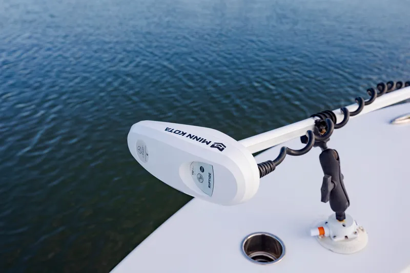 Slide: The Image of Trolling motor on a 2021 ZCB 26 Freemason boat, positioned over water. - 23