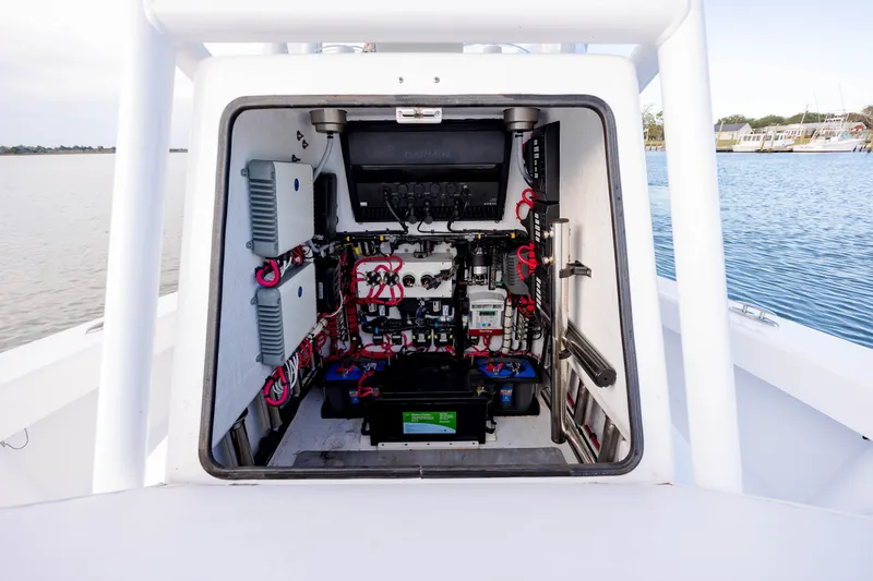 Slide: The Image of 2021 ZCB 26 Freemason boat electrical compartment with wiring and components, dockside view. - 24