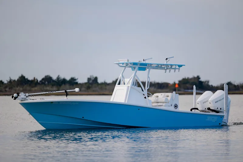 Slide: The Image of Blue 2021 ZCB 26 Freemason boat on calm water, featuring dual engines and a T-top. - 5