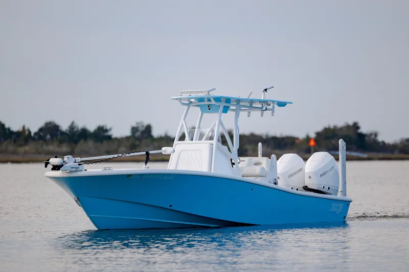 Slide: The Image of 2021 ZCB 26 Freemason boat on calm water, featuring dual engines and a sleek blue design. - 6