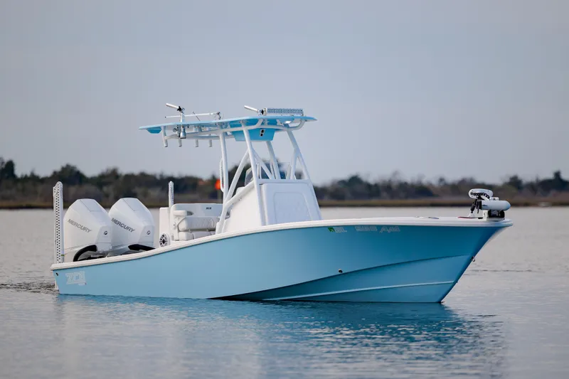 Slide: The Image of 2021 ZCB 26 Freemason boat on calm water, featuring dual engines and a sleek blue design. - 8