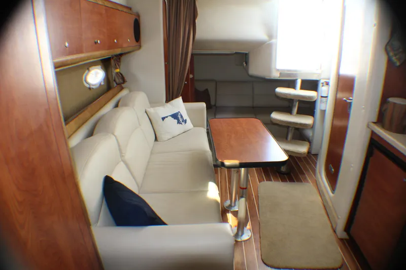Slide: The Image of Interior of 2007 Rinker 350 Express Cruiser with cozy seating and wooden accents. - 11