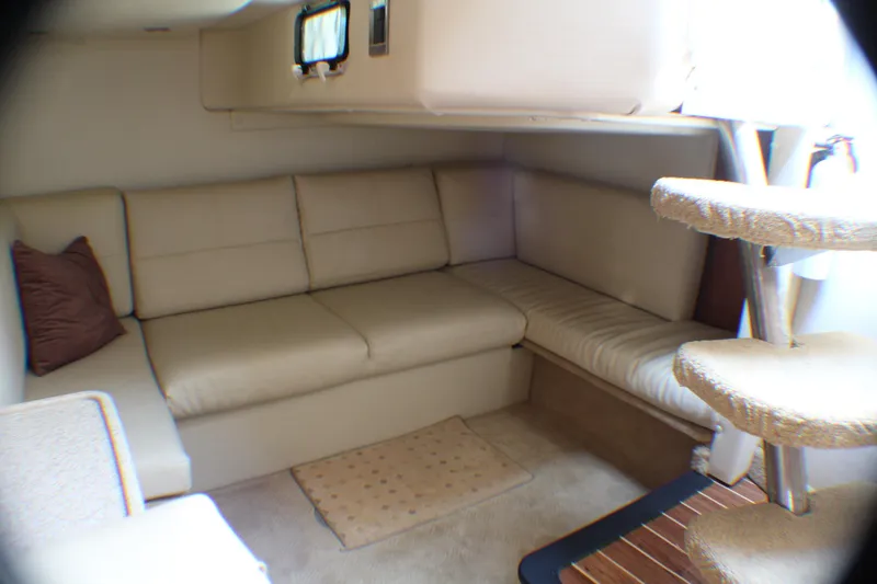 Slide: The Image of 2007 Rinker 350 Express Cruiser interior with beige seating and carpeted floor. - 14
