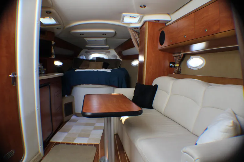 Slide: The Image of Interior of 2007 Rinker 350 Express Cruiser with cozy seating and sleeping area. - 16