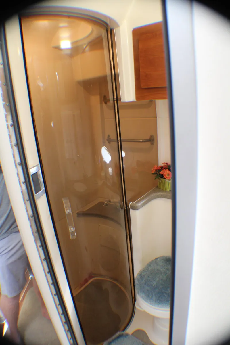 Slide: The Image of 2007 Rinker 350 Express Cruiser bathroom with shower and seating area. - 18
