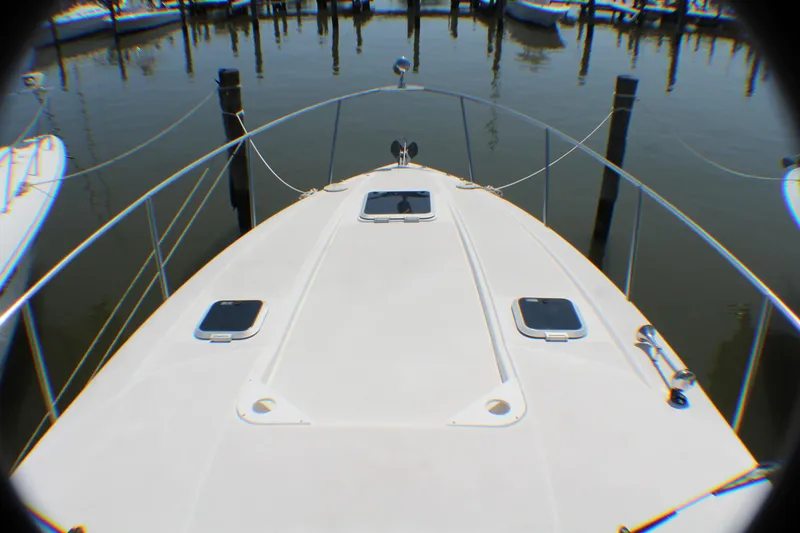 Slide: The Image of 2007 Rinker 350 Express Cruiser bow view at marina. - 19