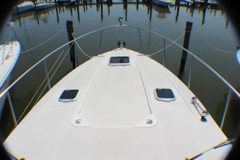 Slide: The Image of 2007 Rinker 350 Express Cruiser bow view at marina. - 20