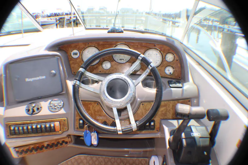 Slide: The Image of Helm of 2007 Rinker 350 Express Cruiser with steering wheel and controls. - 26