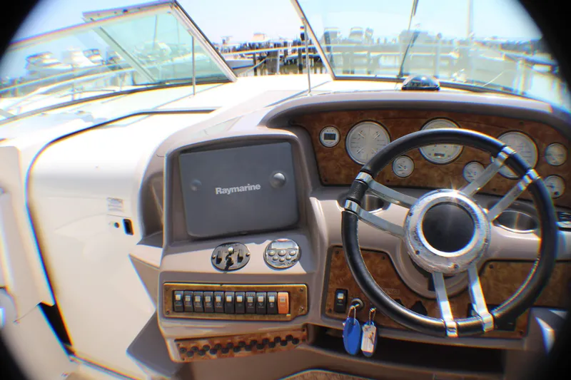 Slide: The Image of 2007 Rinker 350 Express Cruiser dashboard with steering wheel and Raymarine navigation system. - 27