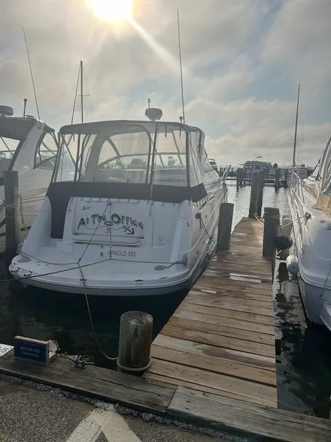 Slide: The Image of 2007 Rinker 350 Express Cruiser docked at marina under cloudy sky. - 30