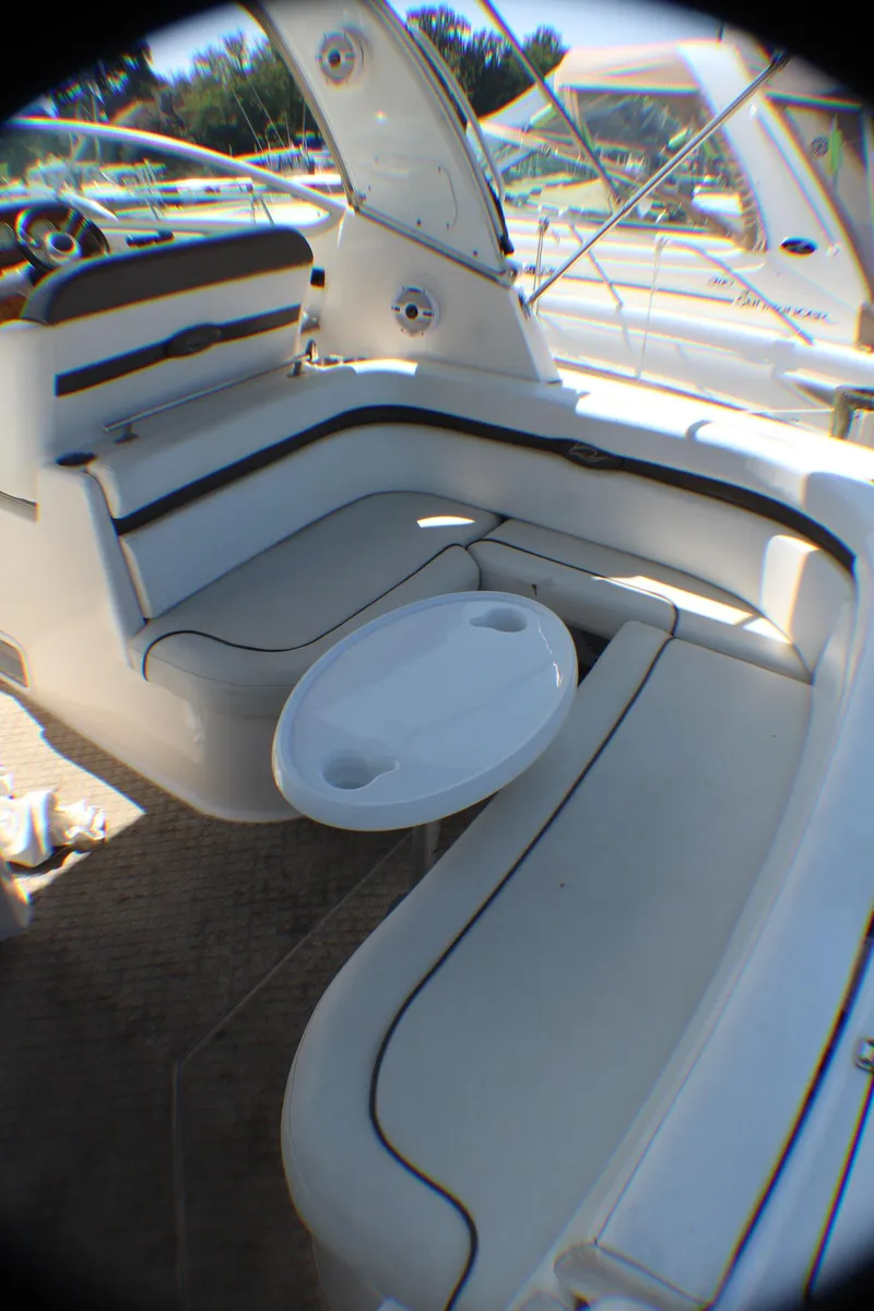Slide: The Image of 2007 Rinker 350 Express Cruiser interior with white seating and table. - 4