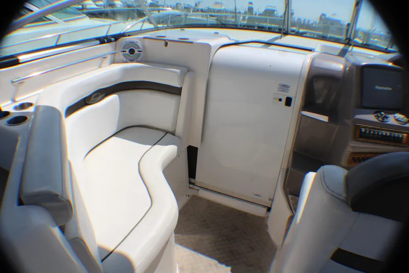 Slide: The Image of 2007 Rinker 350 Express Cruiser interior with white seating and control panel. - 7