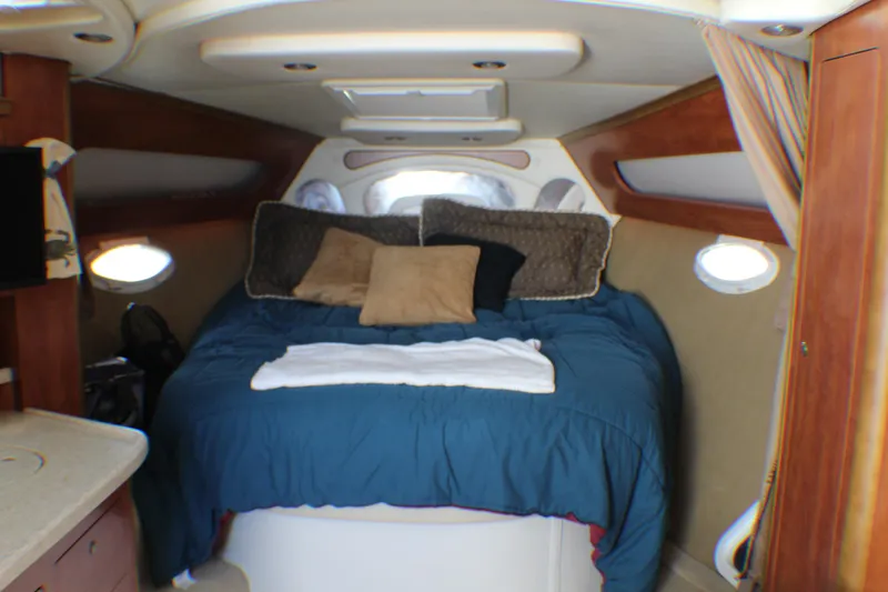 Slide: The Image of Interior of 2007 Rinker 350 Express Cruiser with cozy bed and porthole windows. - 8