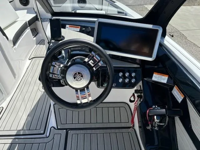 Slide: The Image of 2025 Yamaha Boats 222SD dashboard with steering wheel and touchscreen display. - 10