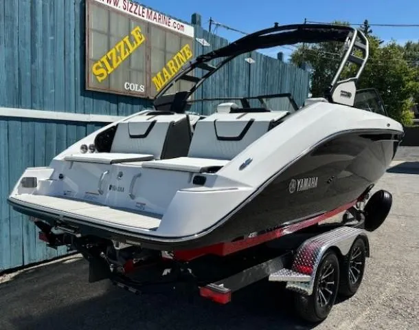 Slide: The Image of 2025 Yamaha Boats 222SD on trailer, displayed at Sizzle Marine dealership. - 2