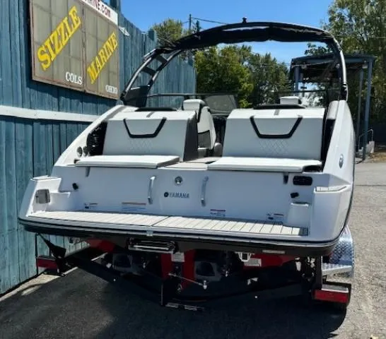 Slide: The Image of 2025 Yamaha Boats 222SD on trailer, rear view, parked outdoors. - 3