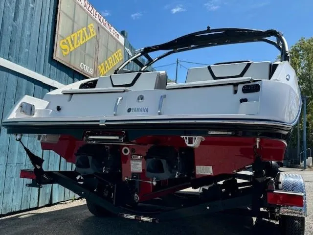 Slide: The Image of 2025 Yamaha Boats 222SD on trailer, displayed at Sizzle Marine dealership. - 4
