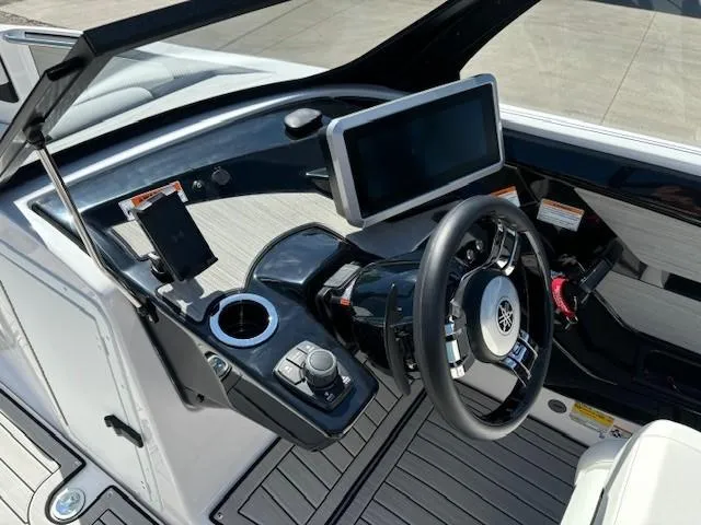 Slide: The Image of 2025 Yamaha Boats 222SD dashboard with modern steering wheel and touchscreen display. - 9
