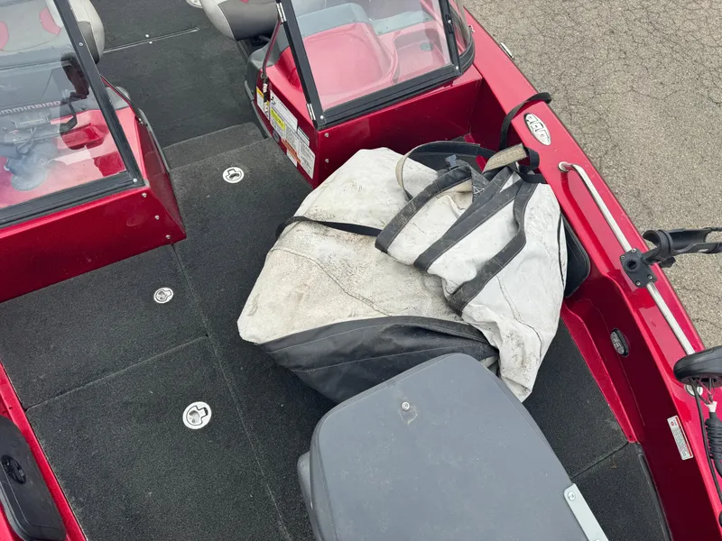 Slide: The Image of 2014 Skeeter WX 2060 boat interior with gear bag on black carpeted floor. - 16