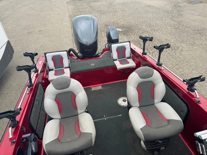 Slide: The Image of 2014 Skeeter WX 2060 boat interior with seating and fishing rod holders. - 19