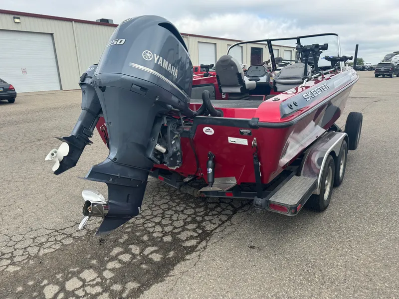 Slide: The Image of 2014 Skeeter WX 2060 boat with Yamaha motor, parked on a trailer. - 3