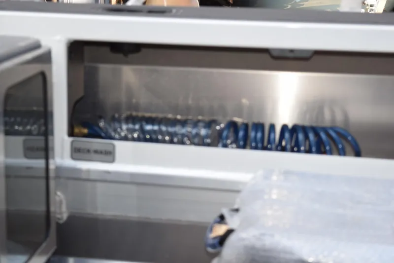 Slide: The Image of 2024 Stabicraft 1550 Frontier SportFish deck wash system with coiled hose. - 14