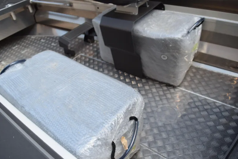 Slide: The Image of 2024 Stabicraft 1550 Frontier SportFish interior with wrapped equipment on metal flooring. - 15