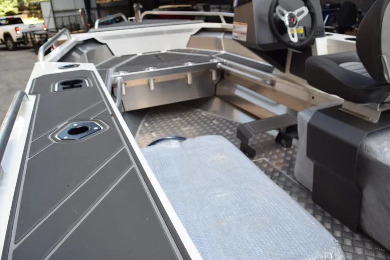 Slide: The Image of 2024 Stabicraft 1550 Frontier SportFish interior with seating and steering console. - 16