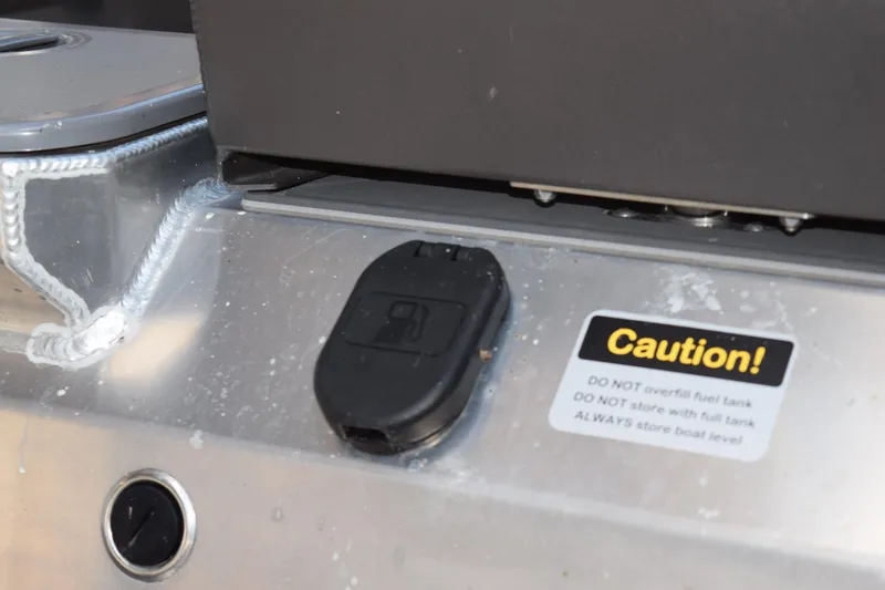 Slide: The Image of Close-up of 2024 Stabicraft 1550 Frontier SportFish fuel cap with caution label. - 4