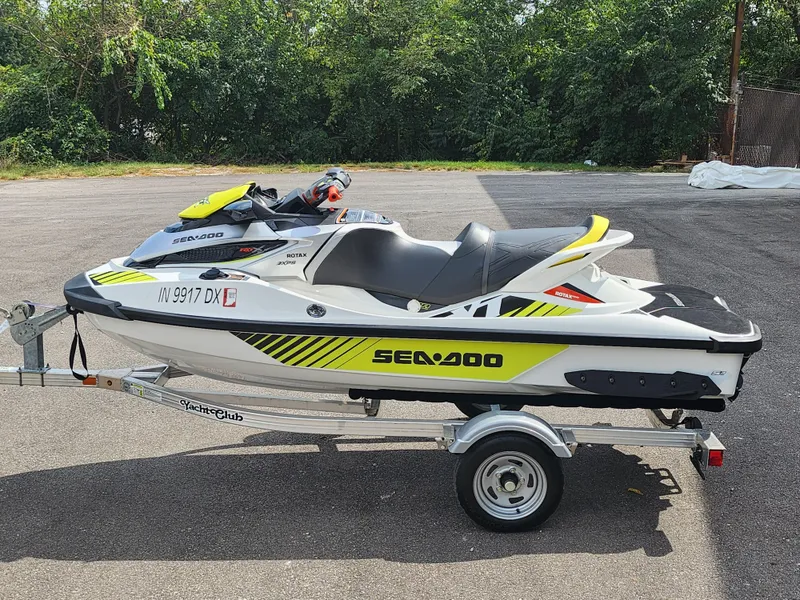 Slide: The Image of 2016 Sea-Doo RXT-X aS 260 jet ski on trailer, parked outdoors. - 0