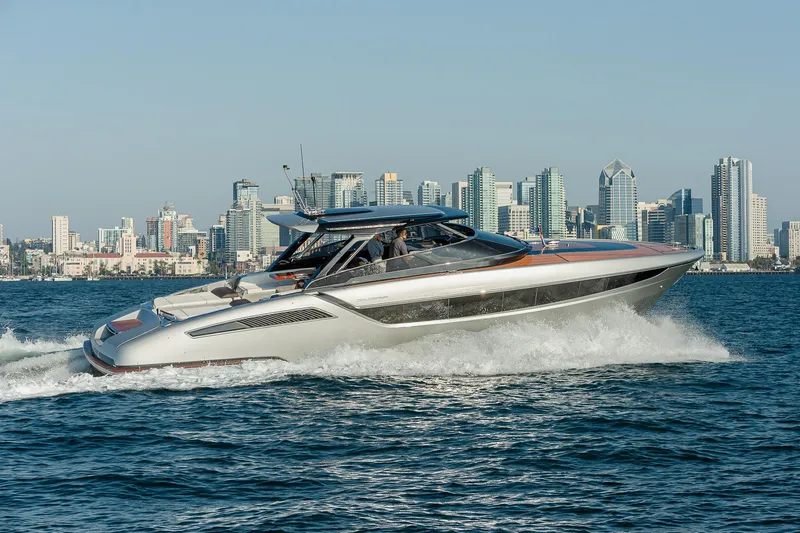 The Image of 2024 Riva 48 Dolceriva yacht cruising with city skyline backdrop. - 0