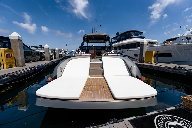 Slide: The Image of 2024 Riva 48 Dolceriva luxury yacht docked at marina under blue sky. - 13