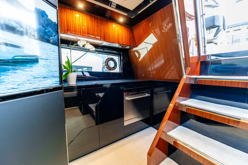 Slide: The Image of Luxurious interior of 2024 Riva 48 Dolceriva yacht with modern kitchen and wooden stairs. - 25