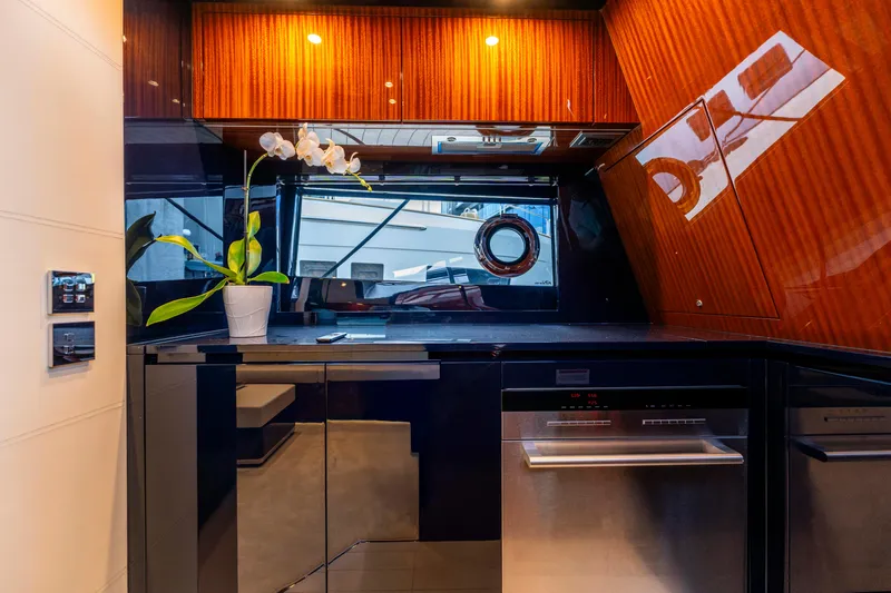 Slide: The Image of Luxurious kitchen interior of 2024 Riva 48 Dolceriva yacht with modern appliances and elegant wood finish. - 33