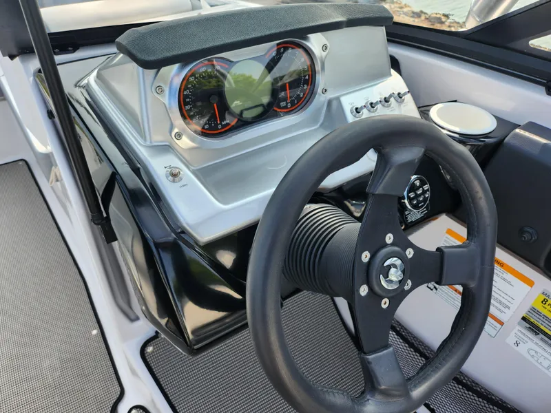 Slide: The Image of 2017 Scarab 195 boat dashboard with steering wheel and gauges. - 15