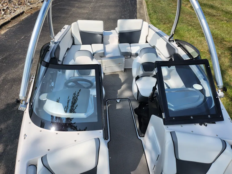 Slide: The Image of 2017 Scarab 195 boat interior with white and gray seating, open cockpit view. - 19