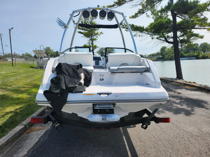 Slide: The Image of 2017 Scarab 195 boat on trailer by a lakeside park. - 2