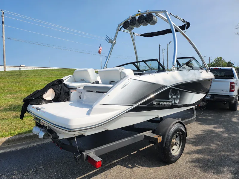 Slide: The Image of 2017 Scarab 195 boat on trailer, sleek design, white and black exterior. - 3