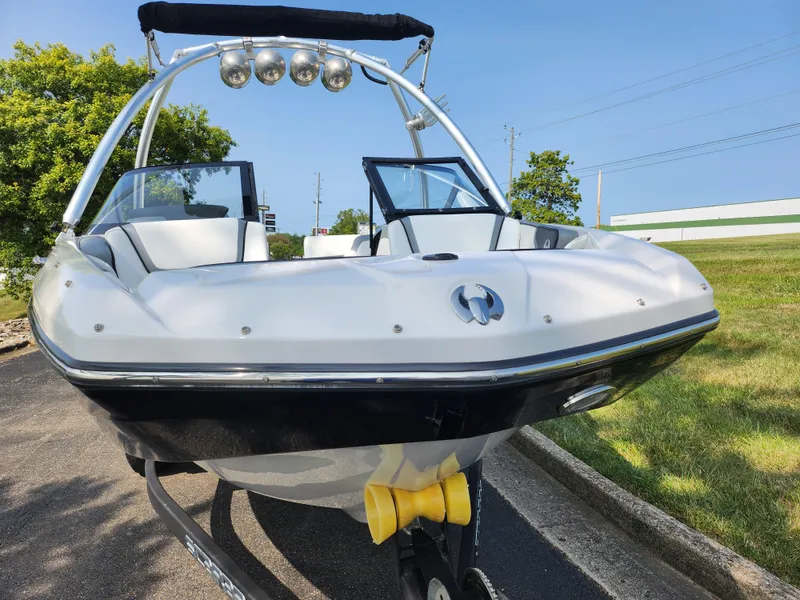 Slide: The Image of 2017 Scarab 195 boat with sleek design and modern features, parked outdoors. - 6