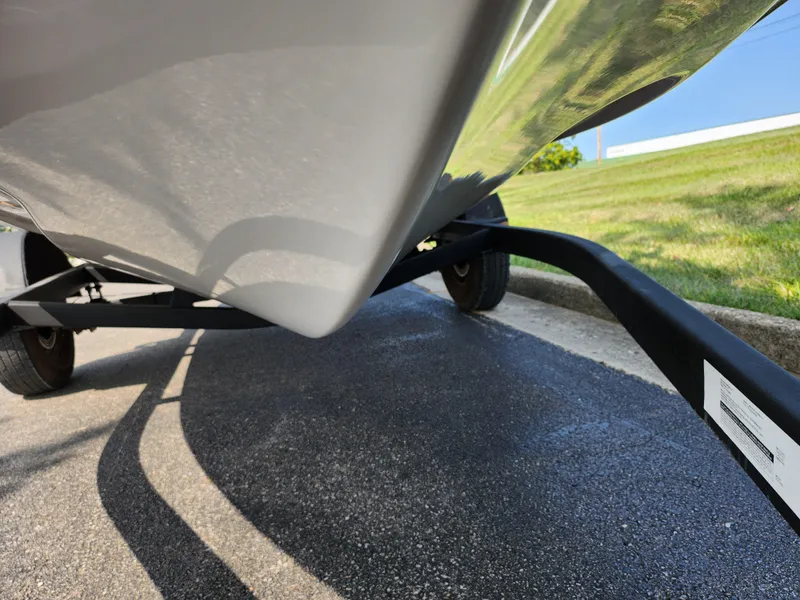 Slide: The Image of 2017 Scarab 195 boat on trailer, close-up view of hull and wheels. - 7