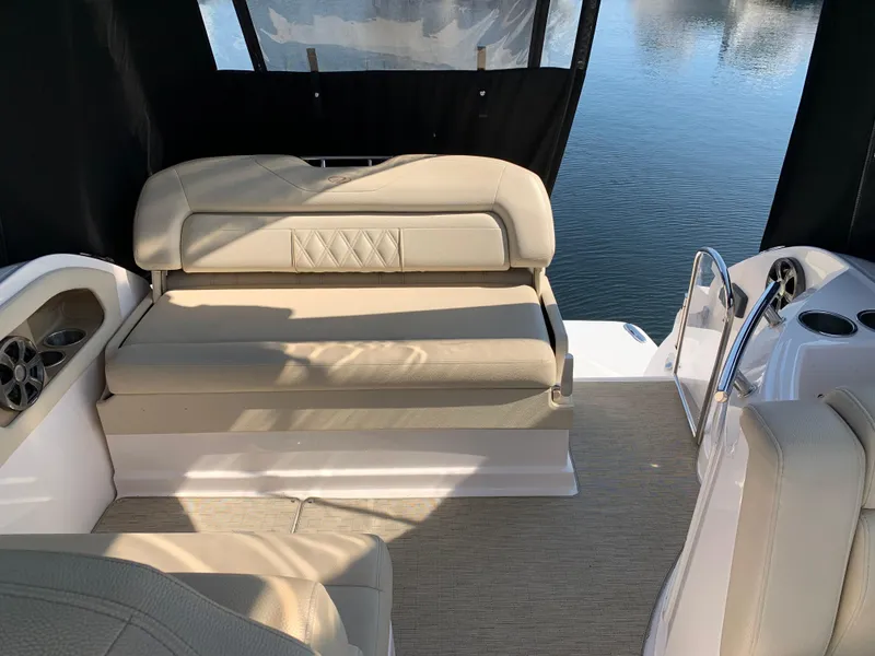 Slide: The Image of Interior of a 2018 Regal 28 Express boat with beige seating area. - 16