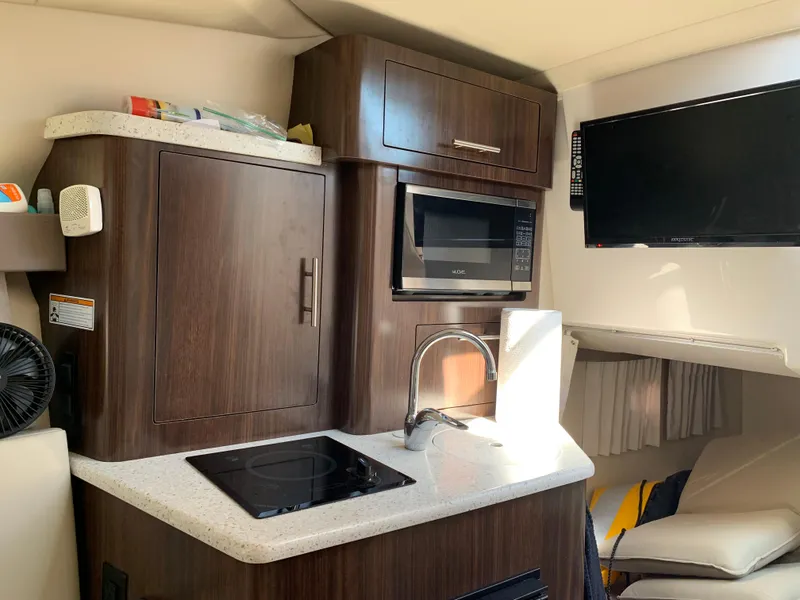 Slide: The Image of Interior of 2018 Regal 28 Express with kitchen and TV. - 24