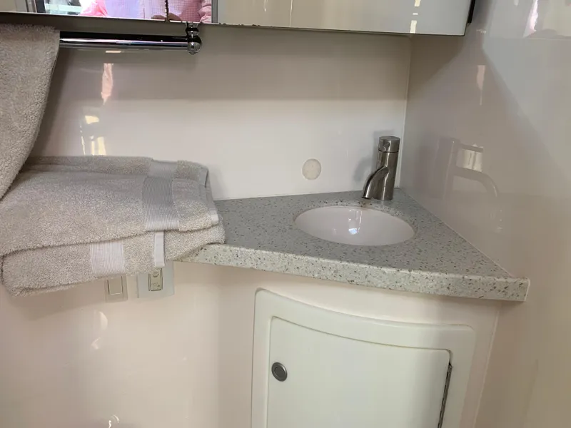 Slide: The Image of Bathroom in 2018 Regal 28 Express with sink and towels. - 28