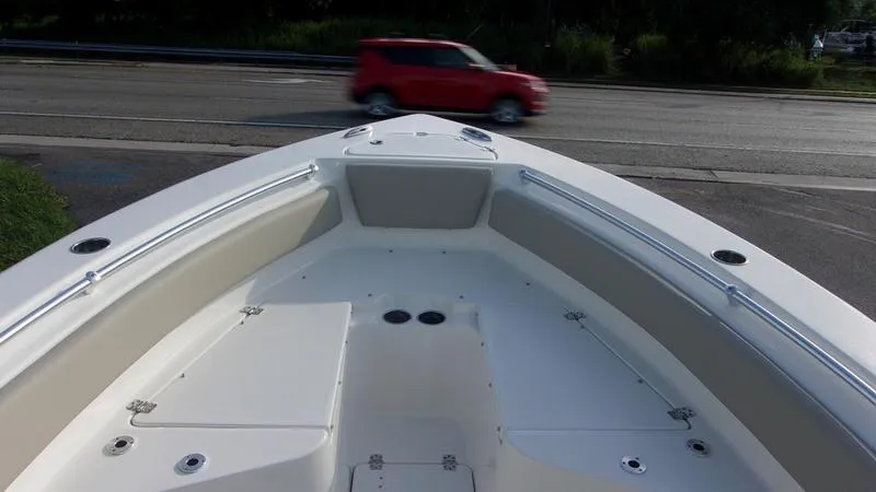 Slide: The Image of Bow view of 2025 Key West 239 FS boat with road and red car in background. - 10