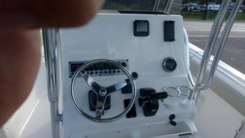 Slide: The Image of 2025 Key West 239 FS boat dashboard with steering wheel and controls. - 13