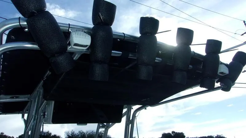 Slide: The Image of Key West 239 FS 2025 boat roof with rod holders against a bright sky. - 14