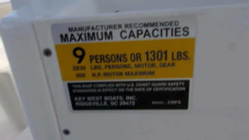 Slide: The Image of Key West 239 FS 2025 boat capacity label: 9 persons or 1301 lbs, 300 HP motor. - 15