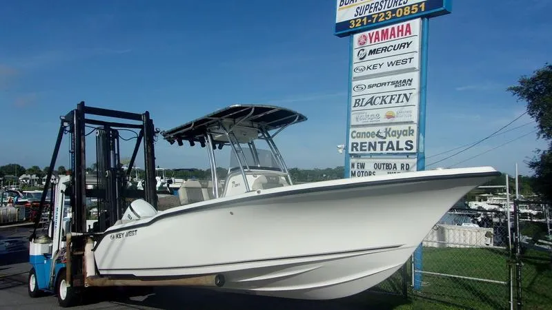 Slide: The Image of 2025 Key West 239 FS boat on forklift near rental sign. - 2