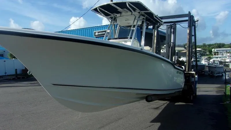 Slide: The Image of 2025 Key West 239 FS boat on forklift at marina, clear sky background. - 3